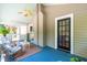 Relax in this screened-in porch with seating, ceiling fan, and an entrance door at 2111 Woodland Ave, Raleigh, NC 27608
