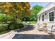 Backyard stone patio with dining area and relaxing outdoor furniture at 2111 Woodland Ave, Raleigh, NC 27608