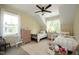 Charming bedroom features two twin beds, a ceiling fan, and a floral patterned wallpaper at 2200 Mays Crossroads Rd, Louisburg, NC 27549