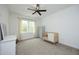 Minimalist bedroom with a crib, a ceiling fan, and neutral colors creating a serene atmosphere at 2200 Mays Crossroads Rd, Louisburg, NC 27549