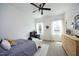 Bright bedroom features a ceiling fan, a bed, a desk, and two windows providing natural light at 2200 Mays Crossroads Rd, Louisburg, NC 27549