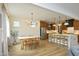 Open dining and kitchen area featuring hardwood floors, ample seating, and natural light at 2200 Mays Crossroads Rd, Louisburg, NC 27549