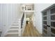 Bright entryway with tall ceilings, staircase, wood floors, and stylish glass paneled doors at 2200 Mays Crossroads Rd, Louisburg, NC 27549