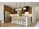 Stylish kitchen featuring a large island with seating, stainless steel appliances, and modern lighting at 2200 Mays Crossroads Rd, Louisburg, NC 27549