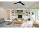 Bright living room with a fireplace, built-in shelves, and a cozy seating arrangement at 2200 Mays Crossroads Rd, Louisburg, NC 27549