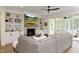 Comfortable living room with a stone fireplace, built-in bookshelves, and sliding doors to patio at 2200 Mays Crossroads Rd, Louisburg, NC 27549