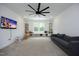 Spacious living room with a large TV, built-in shelves, and a comfortable gray couch at 2200 Mays Crossroads Rd, Louisburg, NC 27549