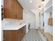 Well-organized mudroom with custom cabinetry, counter space, and a patterned tile floor at 2200 Mays Crossroads Rd, Louisburg, NC 27549