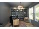 Cozy home office featuring custom built-in shelving, a modern desk, and ample natural light at 2200 Mays Crossroads Rd, Louisburg, NC 27549