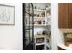 A look at the arched pantry with black paneled door and organized shelving at 2200 Mays Crossroads Rd, Louisburg, NC 27549