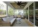 Relaxing screened porch featuring wicker seating and a wooded view at 2200 Mays Crossroads Rd, Louisburg, NC 27549