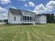 Expansive backyard with lush green lawn and a charming home featuring a screened-in porch at 25 Deer Tail Ln # 52, Fuquay Varina, NC 27526
