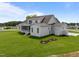 Beautiful backyard with large lawn, white exterior, and screened porch at 25 Deer Tail Ln # 52, Fuquay Varina, NC 27526