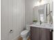 Stylish bathroom with gray wainscoting, dark vanity, and modern fixtures creating a sophisticated retreat at 25 Deer Tail Ln # 52, Fuquay Varina, NC 27526