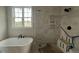 Bathroom featuring a freestanding tub and walk-in shower with a bright window at 25 Deer Tail Ln # 52, Fuquay Varina, NC 27526