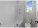 White bathroom with subway tile shower, niche, and neutral paint at 25 Deer Tail Ln # 52, Fuquay Varina, NC 27526