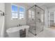 Serene bathroom featuring a freestanding tub, glass-enclosed shower, and ample natural light at 25 Deer Tail Ln # 52, Fuquay Varina, NC 27526