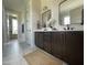 Bathroom featuring double vanity with bronze fixtures and marble floors at 25 Deer Tail Ln # 52, Fuquay Varina, NC 27526