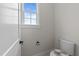 Powder room featuring a modern toilet, natural light, and understated elegance at 25 Deer Tail Ln # 52, Fuquay Varina, NC 27526