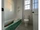 Bathroom featuring a tiled shower, recessed shelves, and a commode with a window at 25 Deer Tail Ln # 52, Fuquay Varina, NC 27526
