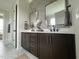 Modern bathroom features a dual vanity, quartz countertops, sleek fixtures, and stylish hexagon tile accents at 25 Deer Tail Ln # 52, Fuquay Varina, NC 27526