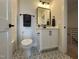 Well-lit bathroom with modern vanity, elegant mirror, and decorative floor tiles for a luxurious feel at 25 Deer Tail Ln # 52, Fuquay Varina, NC 27526