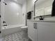 Stylish bathroom featuring modern fixtures, decorative floor tiles, and a shower-tub combination at 25 Deer Tail Ln # 52, Fuquay Varina, NC 27526