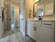 Light-filled bathroom with double vanity, undermount sinks and a large, framed mirror at 25 Deer Tail Ln # 52, Fuquay Varina, NC 27526