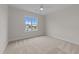 Neutral bedroom features carpet and large window offering neighborhood views at 25 Deer Tail Ln # 52, Fuquay Varina, NC 27526