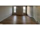 Unfinished bedroom with hardwood floors and windows overlooking a sunny neighborhood at 25 Deer Tail Ln # 52, Fuquay Varina, NC 27526