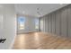 Spacious bedroom with wood floors, statement wall, and natural light from dual windows at 25 Deer Tail Ln # 52, Fuquay Varina, NC 27526