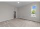 Bright bedroom with neutral carpet, fan, and natural light from a window with views of the surrounding landscape at 25 Deer Tail Ln # 52, Fuquay Varina, NC 27526