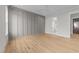 Large bedroom with a stylish accent wall, wood floors, and an en-suite bathroom at 25 Deer Tail Ln # 52, Fuquay Varina, NC 27526