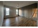 Unfinished bedroom with hardwood floors and windows overlooking a sunny neighborhood at 25 Deer Tail Ln # 52, Fuquay Varina, NC 27526