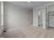 Bedroom with neutral walls, a ceiling fan, and carpet; bathroom and closet doors visible at 25 Deer Tail Ln # 52, Fuquay Varina, NC 27526