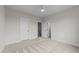 Bedroom featuring neutral walls, plush carpeting, and multiple doors leading to other areas at 25 Deer Tail Ln # 52, Fuquay Varina, NC 27526
