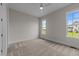 Comfortable bedroom with two bright windows and neutral walls and carpet at 25 Deer Tail Ln # 52, Fuquay Varina, NC 27526