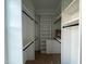Bright open closet with multiple shelves and chrome closet rod fixtures at 25 Deer Tail Ln # 52, Fuquay Varina, NC 27526