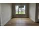 Inviting dining room with hardwood floors and large window overlooking backyard at 25 Deer Tail Ln # 52, Fuquay Varina, NC 27526