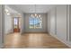 Elegant dining room featuring hardwood floors, decorative trim, large window and stylish chandelier, perfect for entertaining at 25 Deer Tail Ln # 52, Fuquay Varina, NC 27526