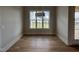 Bright dining room with large window showcasing the green outdoors and modern light fixture at 25 Deer Tail Ln # 52, Fuquay Varina, NC 27526