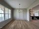 Bright dining room with hardwood floors, paneled walls, and modern chandelier at 25 Deer Tail Ln # 52, Fuquay Varina, NC 27526
