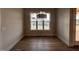 Spacious dining room with hardwood floors, large windows, and modern light fixture at 25 Deer Tail Ln # 52, Fuquay Varina, NC 27526