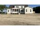 Charming two-story home with a covered porch, white siding, and dark roof set against a blue sky at 25 Deer Tail Ln # 52, Fuquay Varina, NC 27526