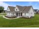 Lovely home boasts a manicured lawn, well-maintained landscaping, and a charming front porch creating inviting curb appeal at 25 Deer Tail Ln # 52, Fuquay Varina, NC 27526