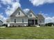 Charming home with stone accents, well-manicured lawn, and inviting front porch at 25 Deer Tail Ln # 52, Fuquay Varina, NC 27526