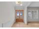 Bright foyer with hardwood floors, a wooden front door, a modern light fixture, and an open view to other rooms at 25 Deer Tail Ln # 52, Fuquay Varina, NC 27526