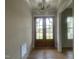 Entryway with hardwood floors, stylish light fixture, and double front doors at 25 Deer Tail Ln # 52, Fuquay Varina, NC 27526