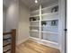 Hallway with built-in shelving offering space for books and decor at 25 Deer Tail Ln # 52, Fuquay Varina, NC 27526