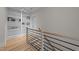 Hallway staircase featuring hardwood steps, a wooden railing, and built-in shelves at 25 Deer Tail Ln # 52, Fuquay Varina, NC 27526